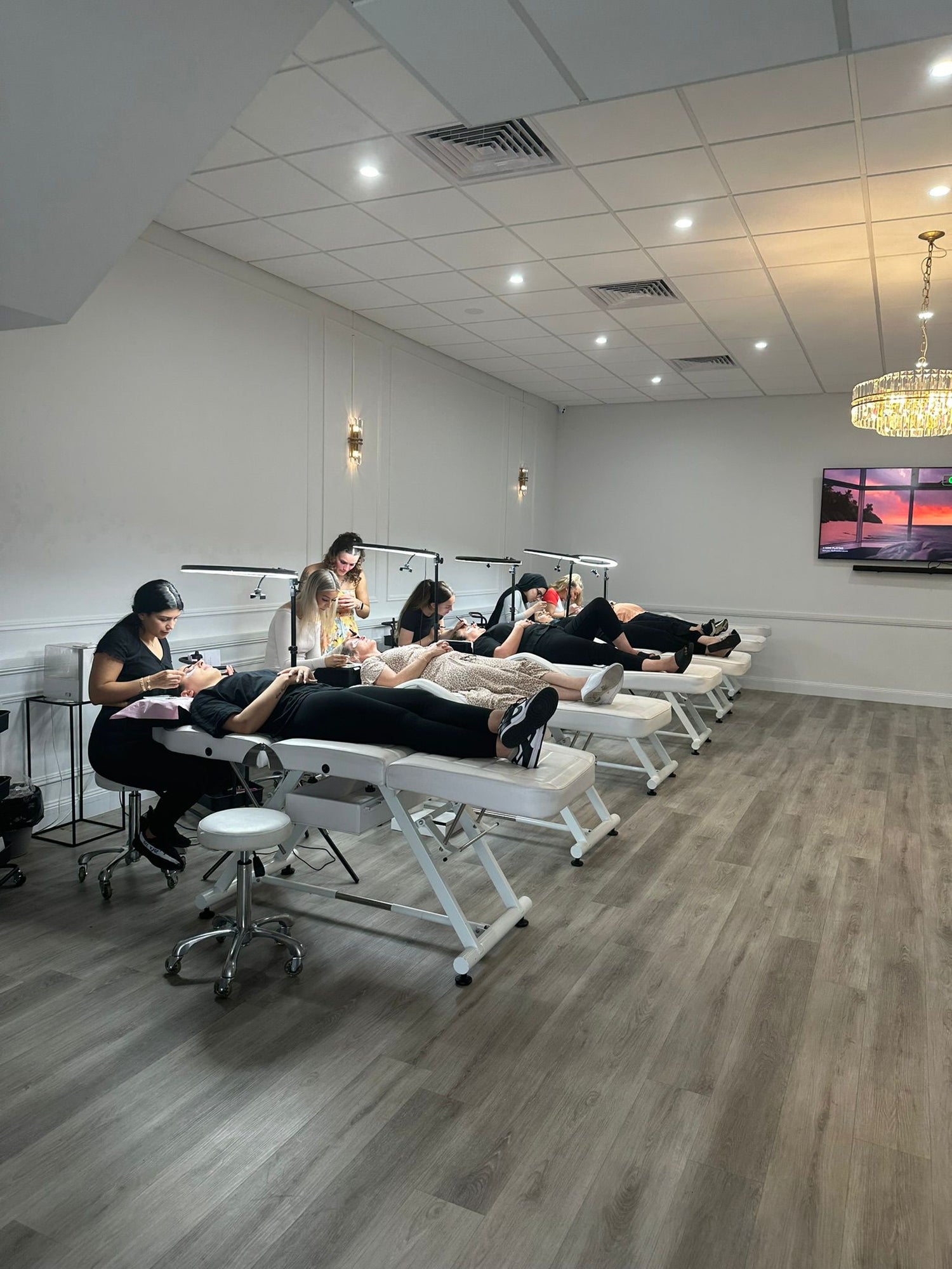 Students happily participating practical application on their models during lash class